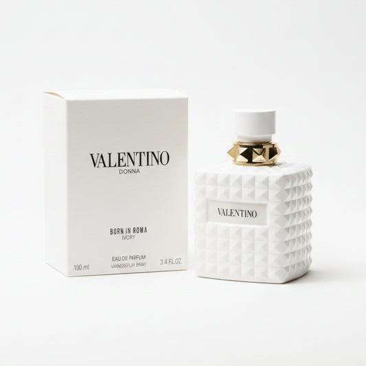 Valentino perfume bottle and packaging on a marble surface with a dark background