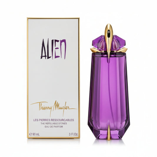 Purple perfume bottle with gold accents next to its packaging on a white background